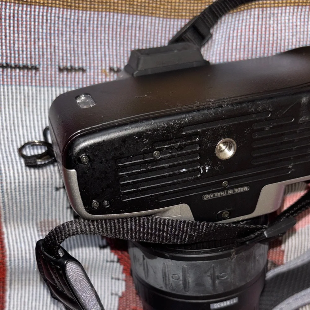 Nikon Silver and Black DSLR with Zoom Lens and Strap